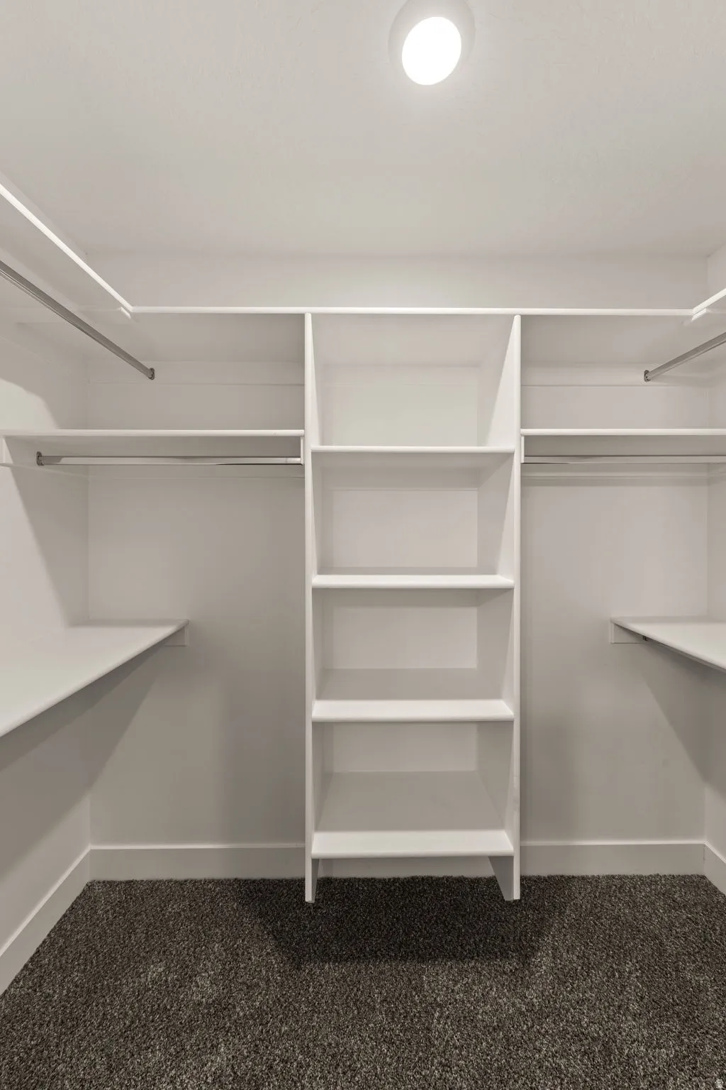 Walk in closet featuring dark carpet