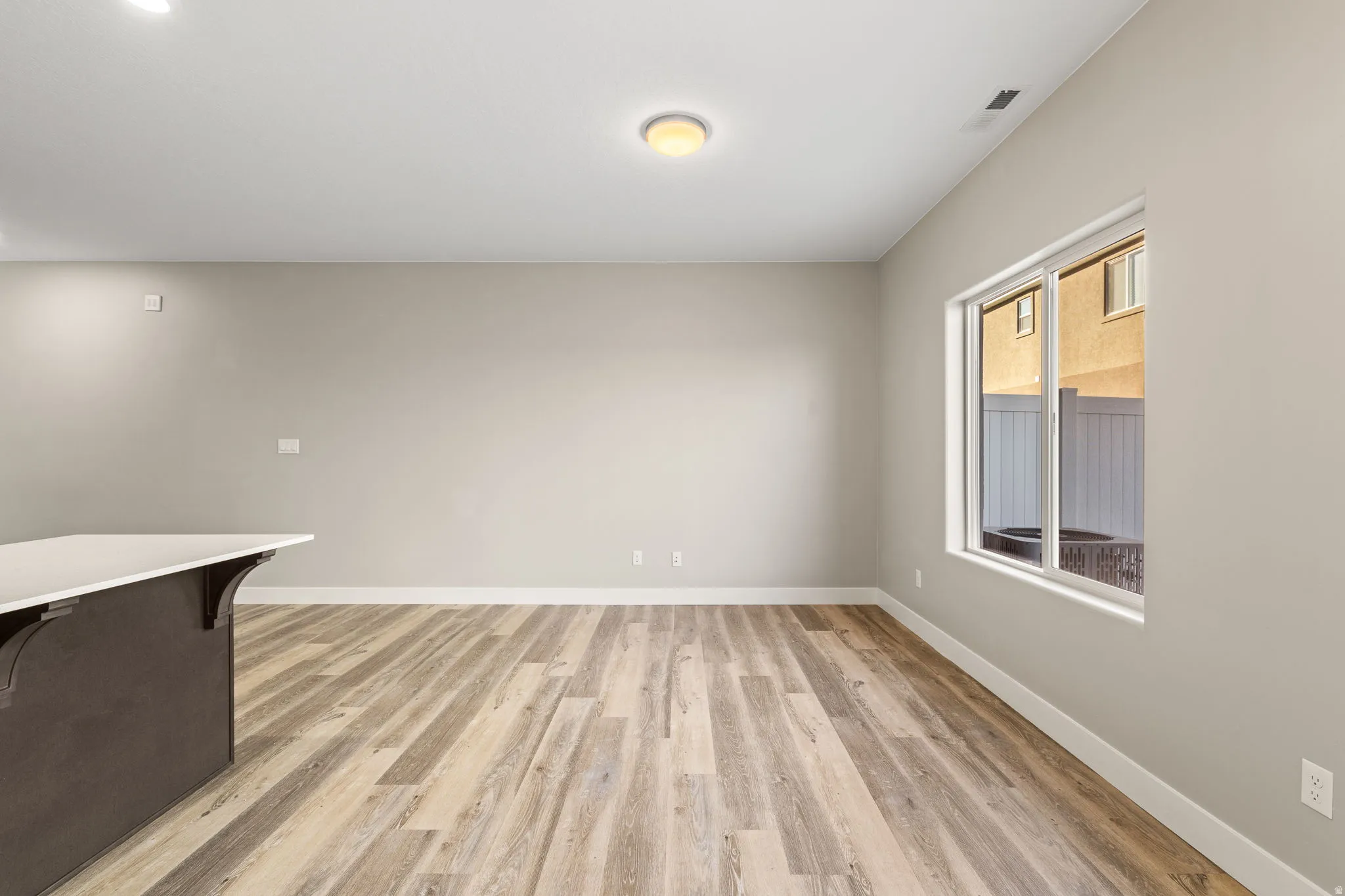 Spare room featuring light wood-style floors and baseboards