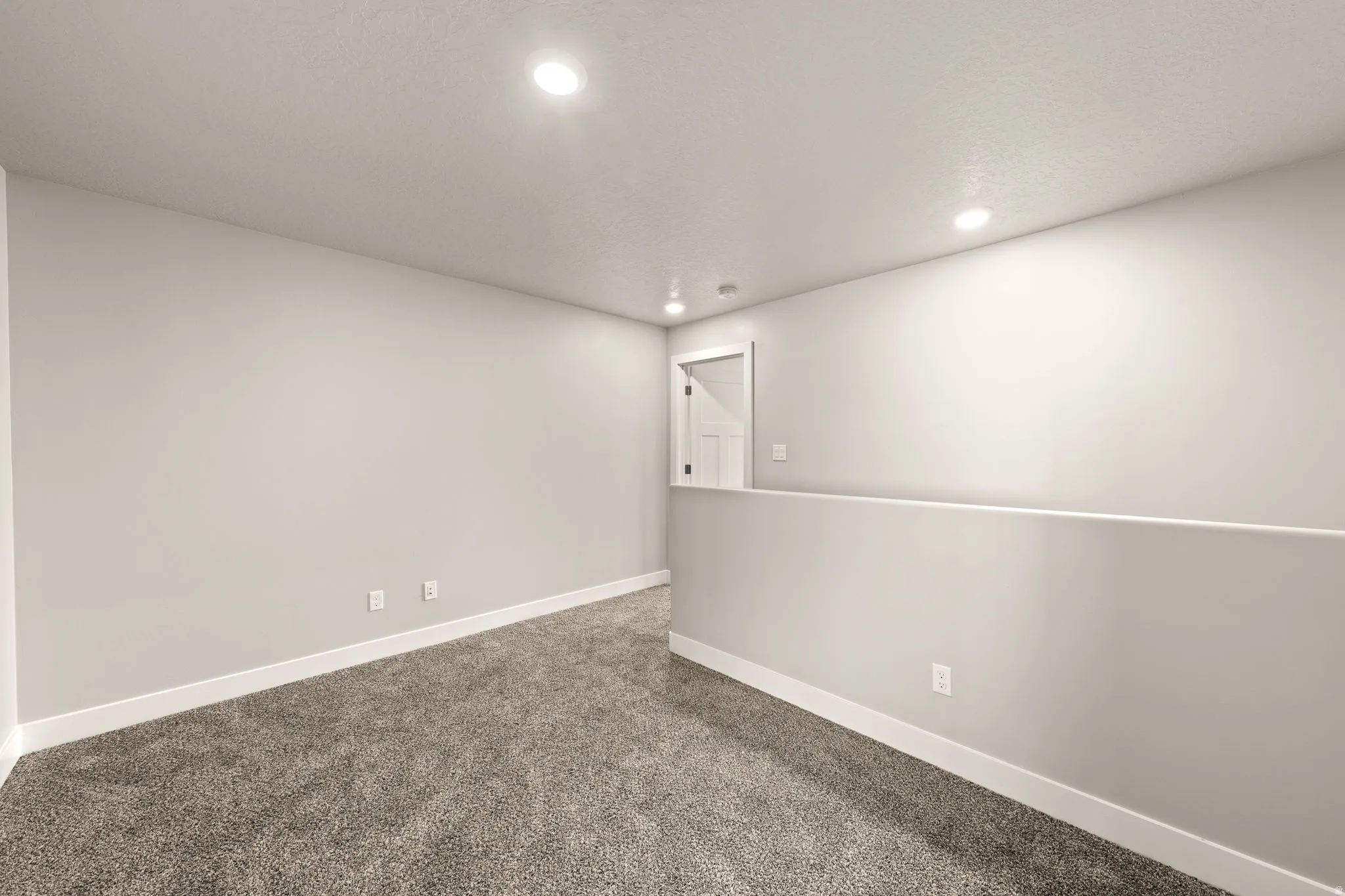 Carpeted spare room featuring baseboards and recessed lighting
