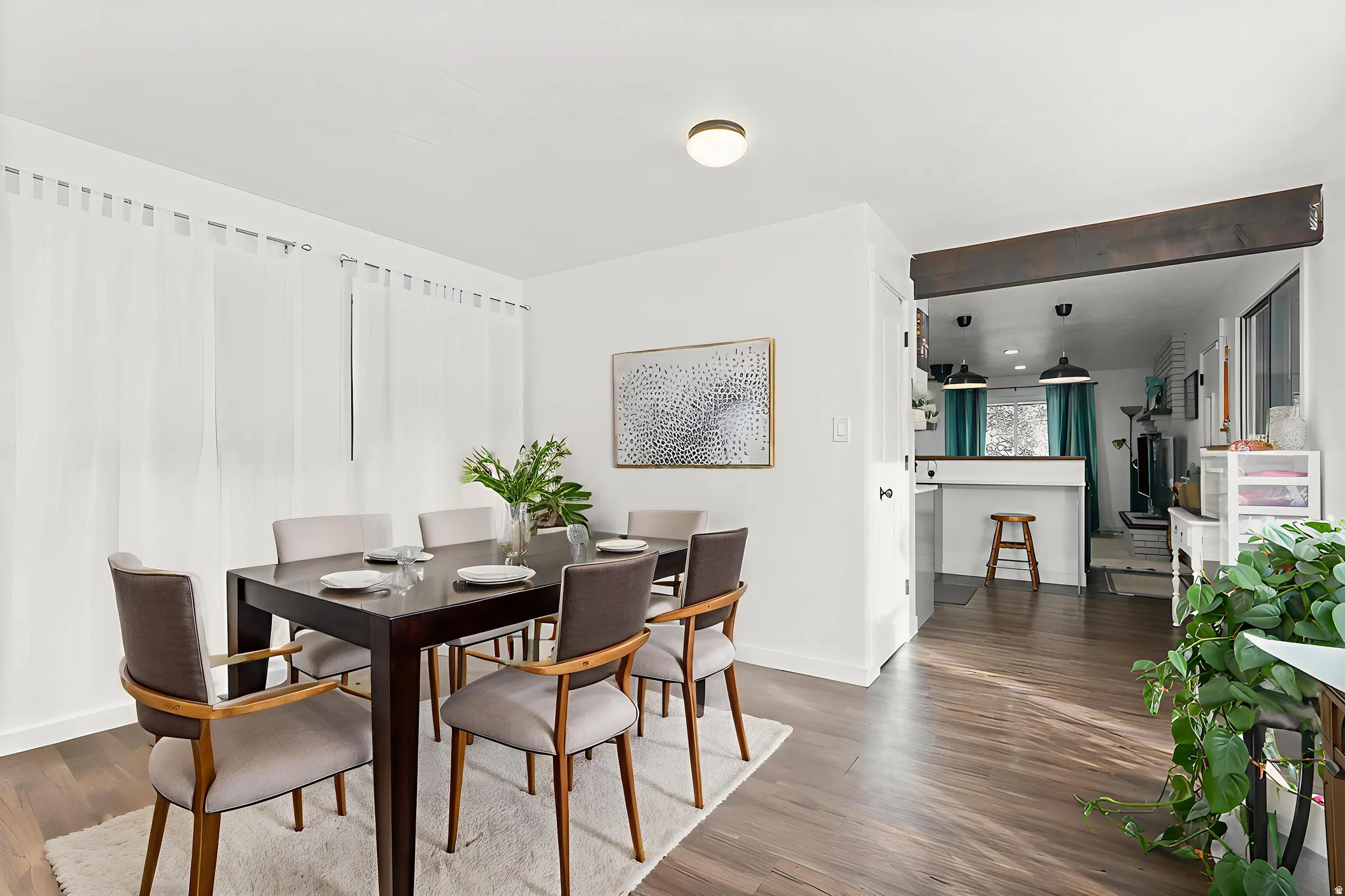 Dining room featuring dark wood finished floors and baseboards