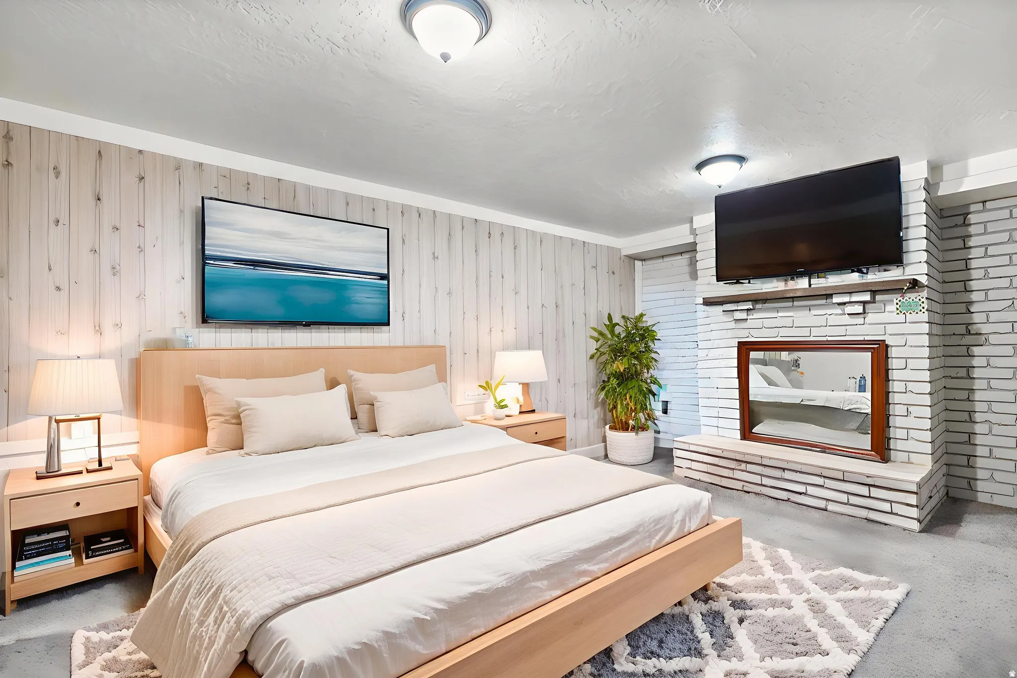 Bedroom featuring finished concrete flooring, wooden walls, and a fireplace
