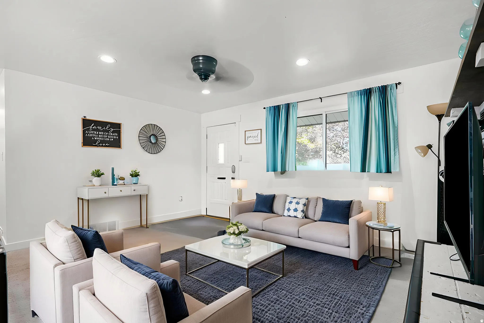 Living room featuring recessed lighting, a ceiling fan, and finished concrete flooring