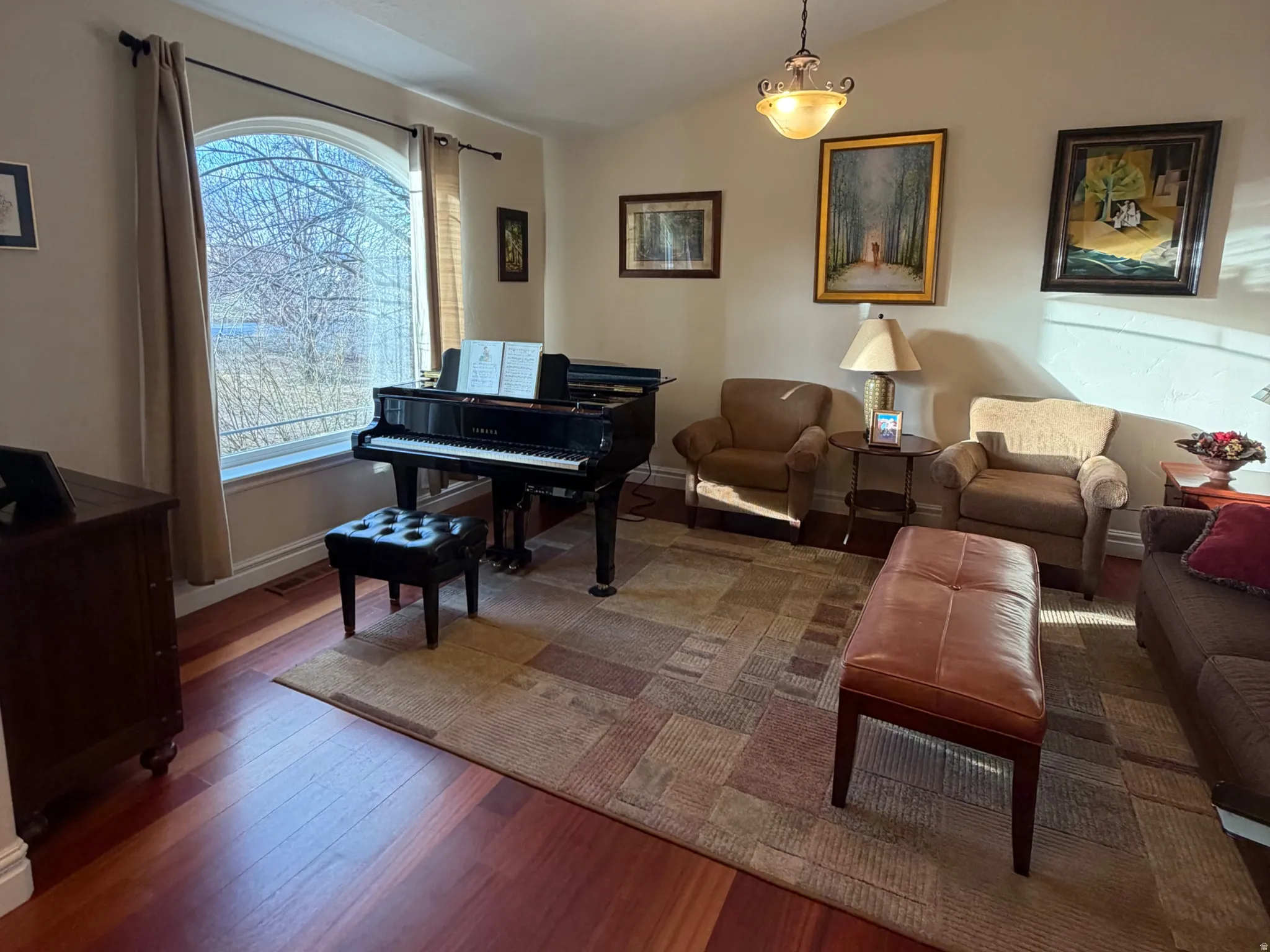 Living room with wood-type flooring and lofted ceiling
