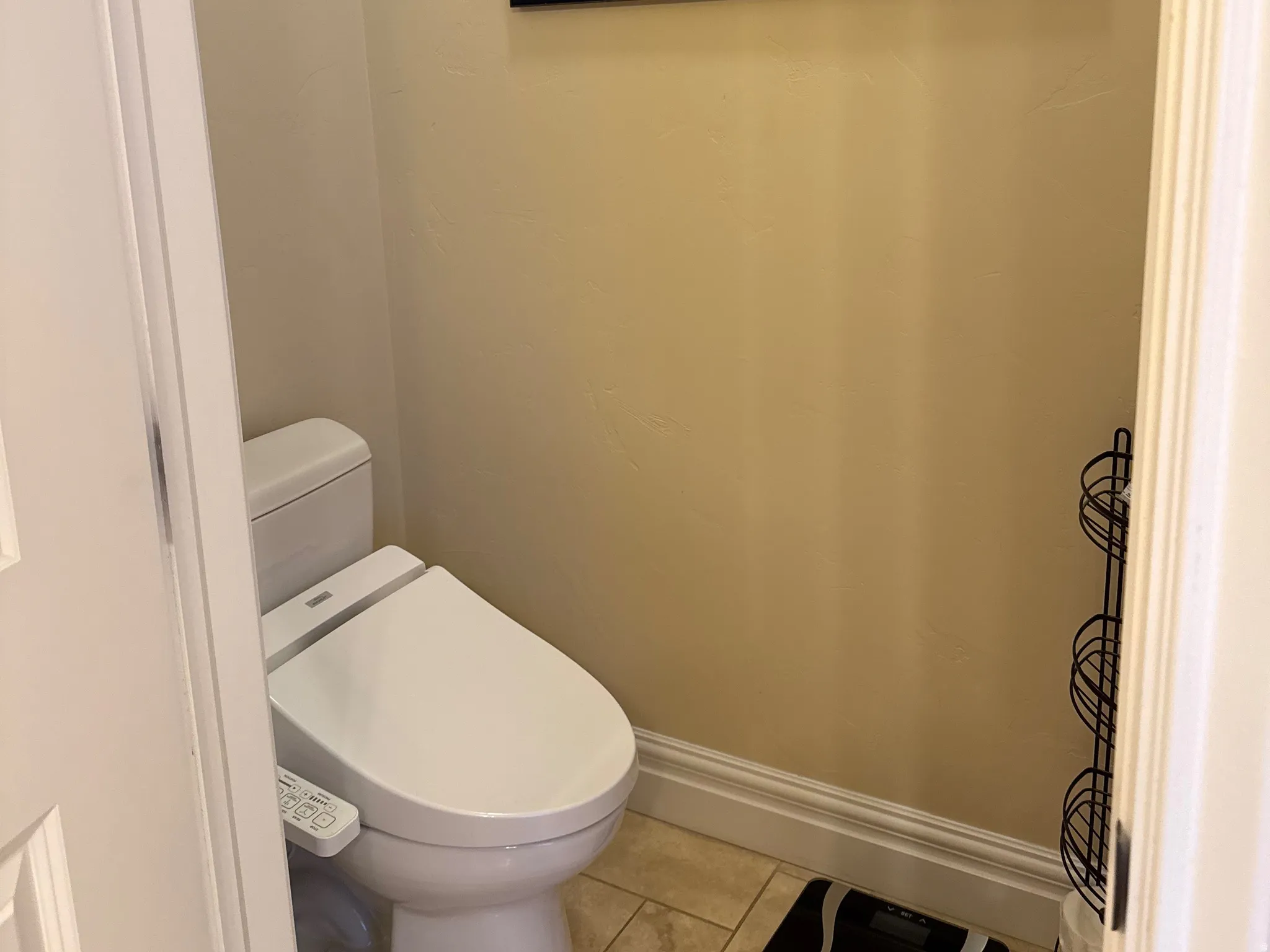 Bathroom featuring baseboards and light tile patterned flooring