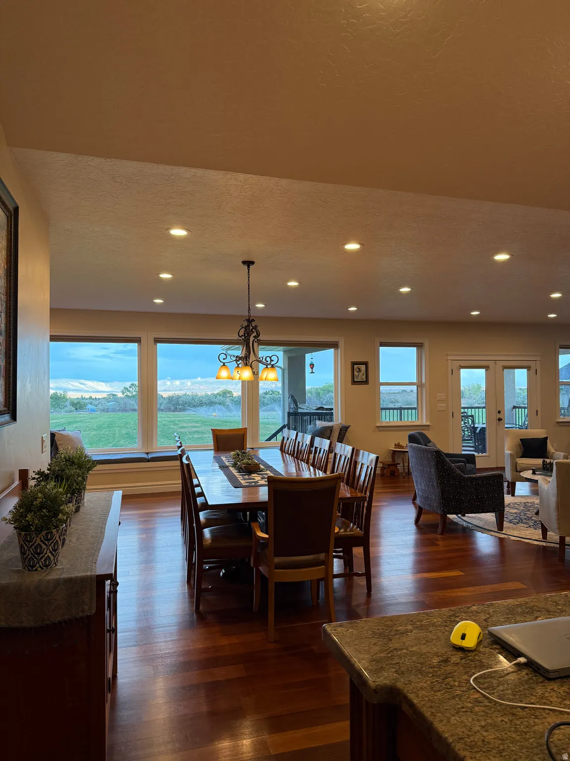 Dining space featuring dark wood finished floors, a chandelier, and a textured ceiling