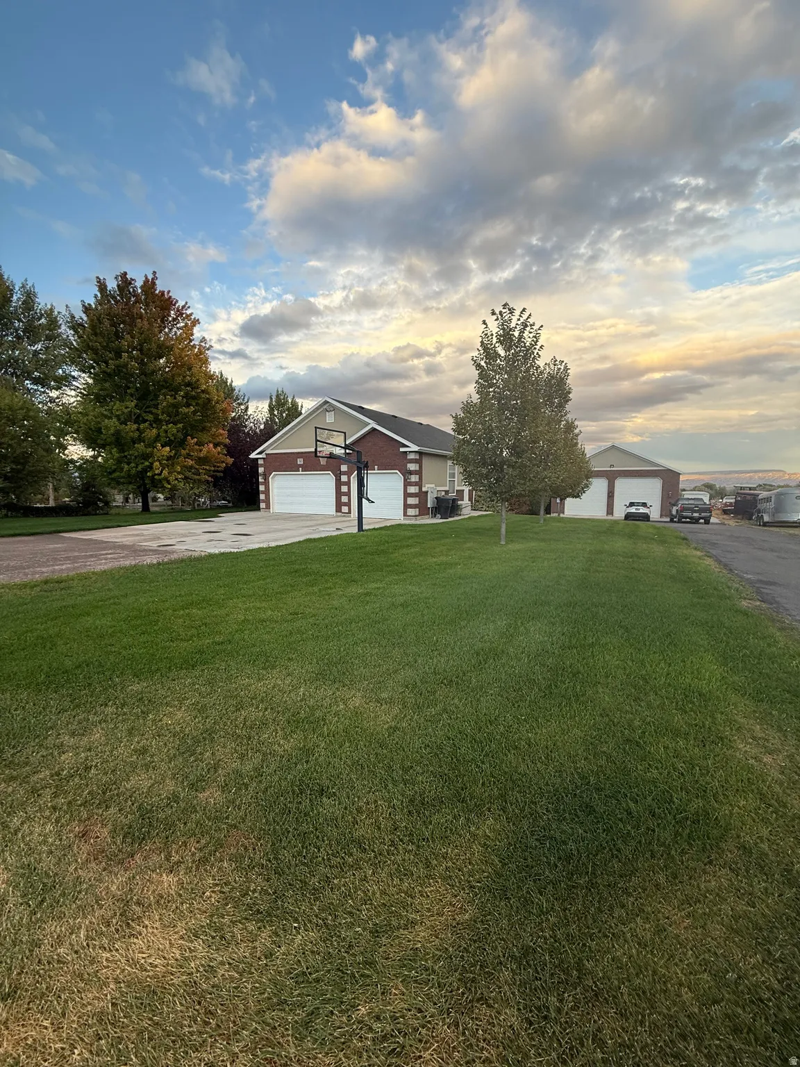 Single story home with a front yard and a detached garage