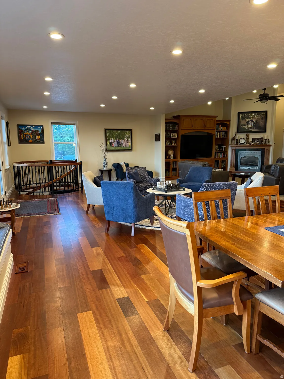 Dining space with dark wood finished floors, recessed lighting, and a ceiling fan