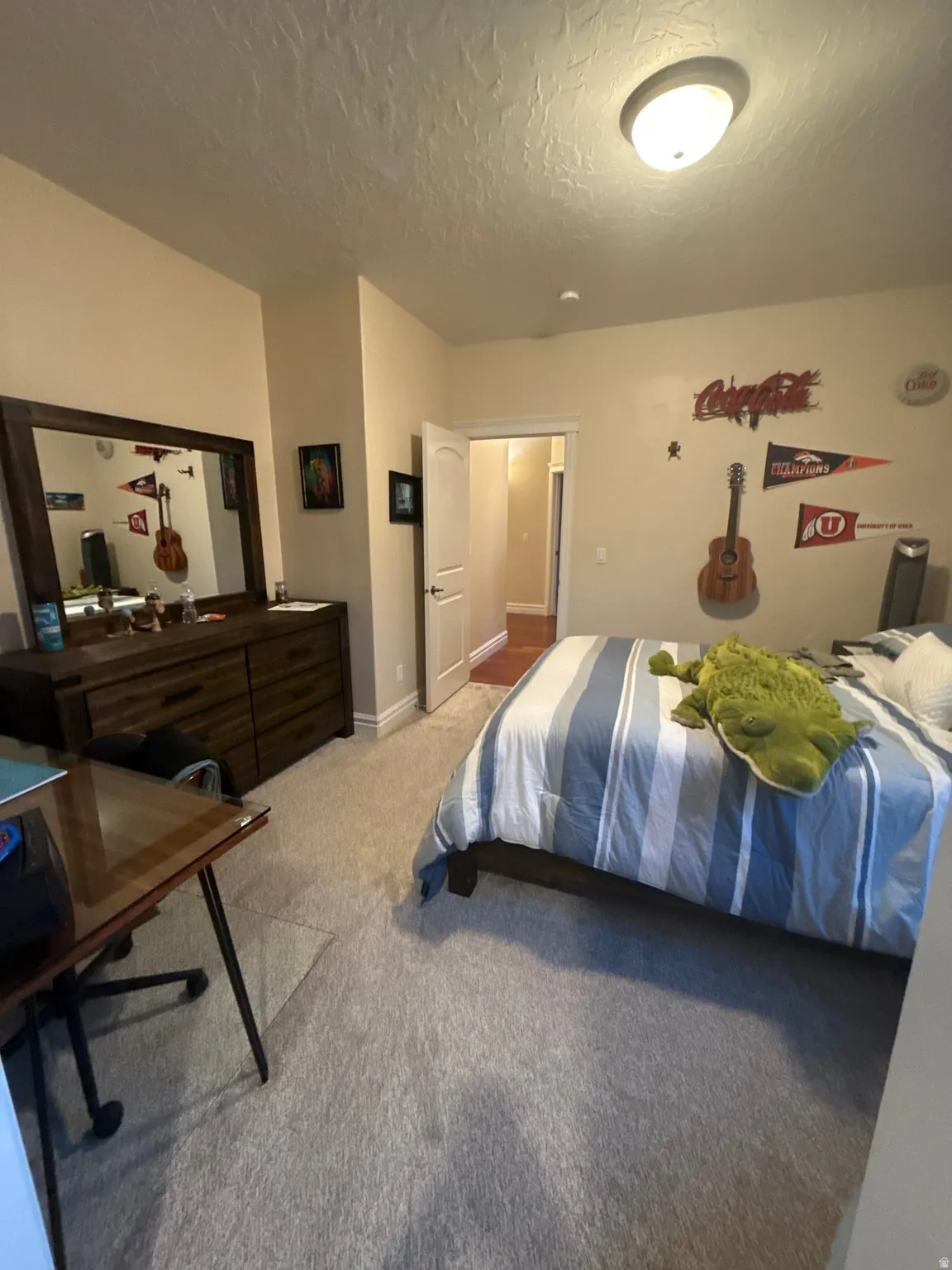 Bedroom featuring light carpet and a textured ceiling