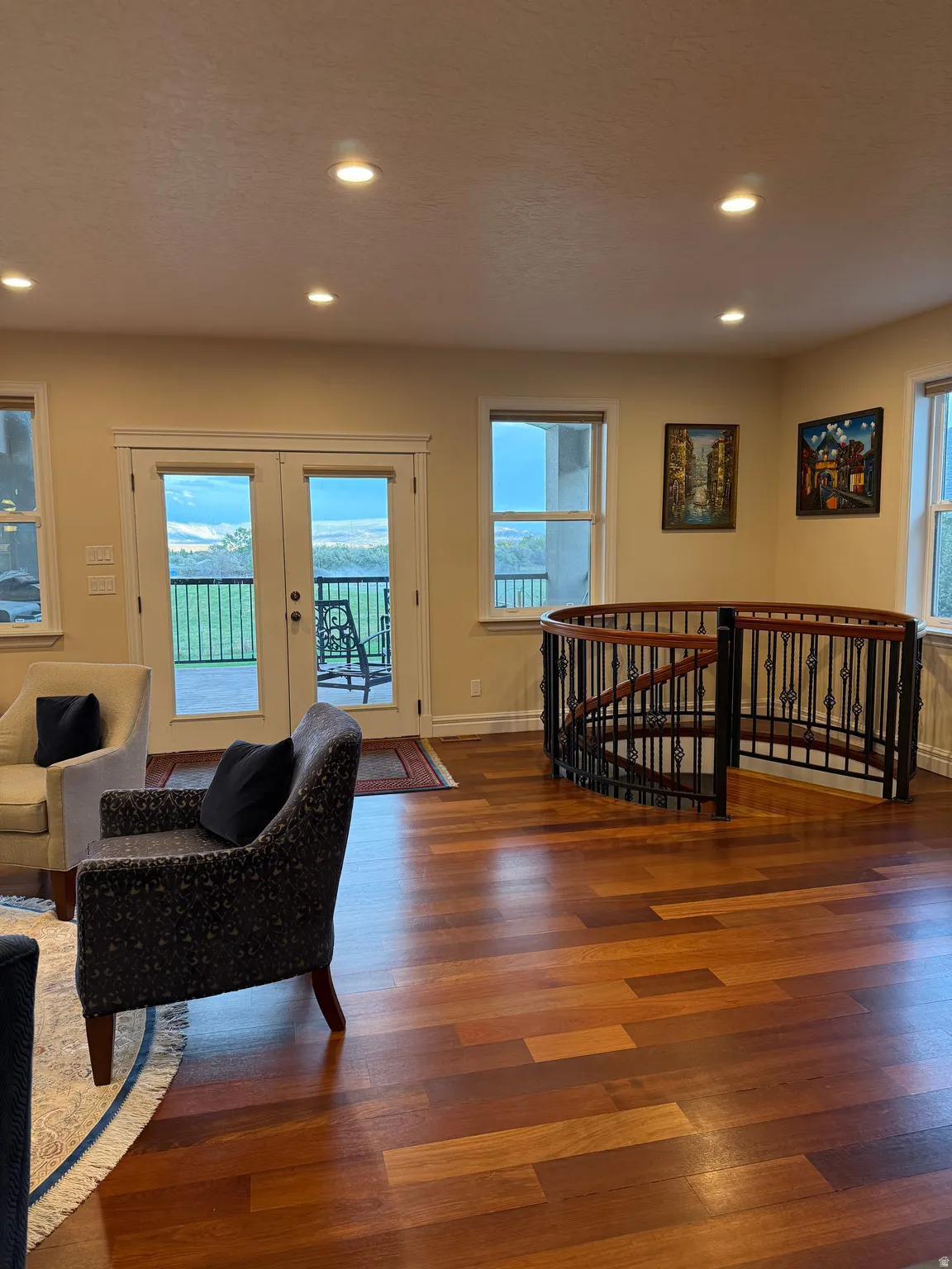 Living room with recessed lighting, wood finished floors, french doors, and plenty of natural light