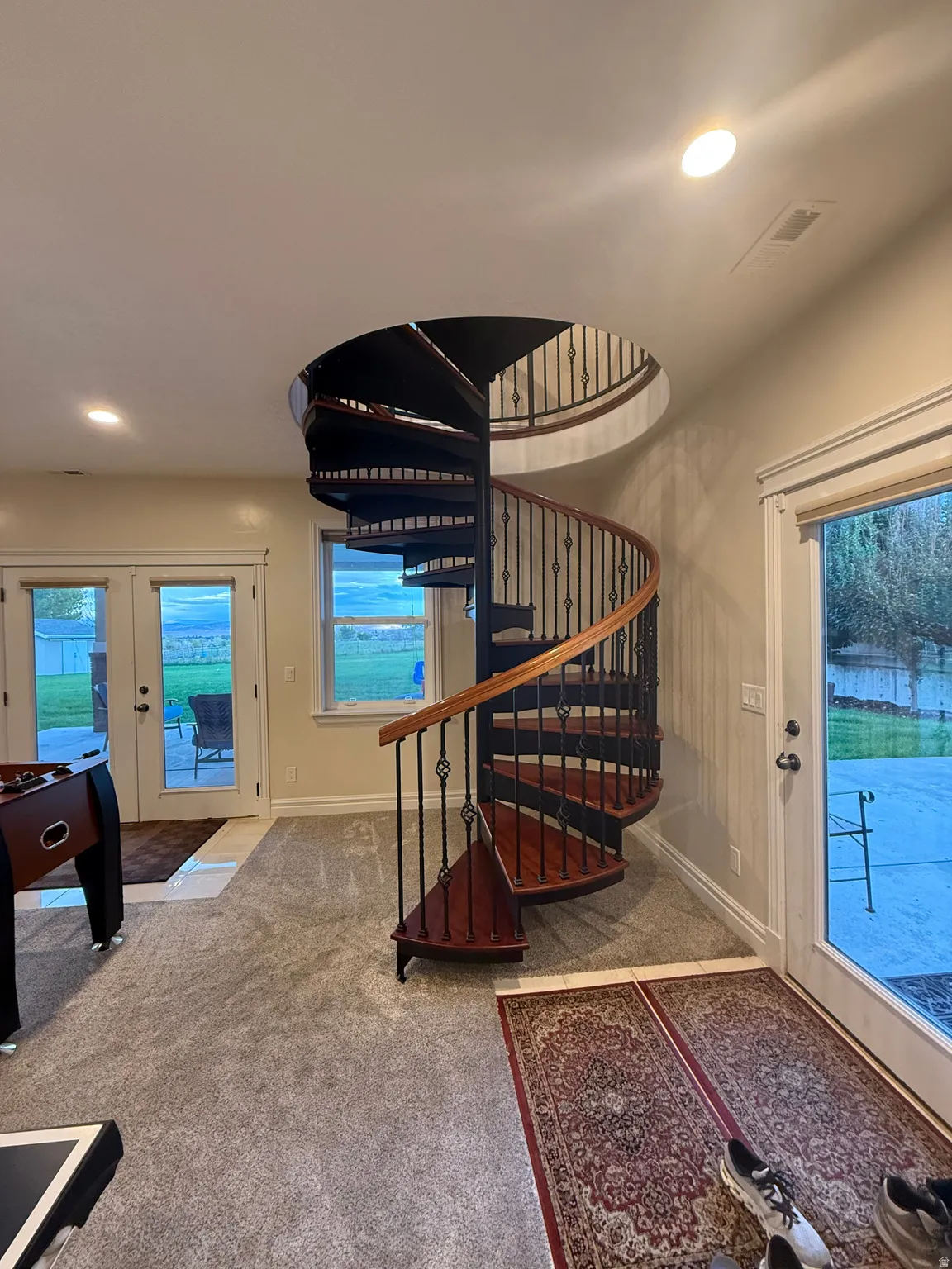 Stairway featuring carpet flooring, recessed lighting, and french doors
