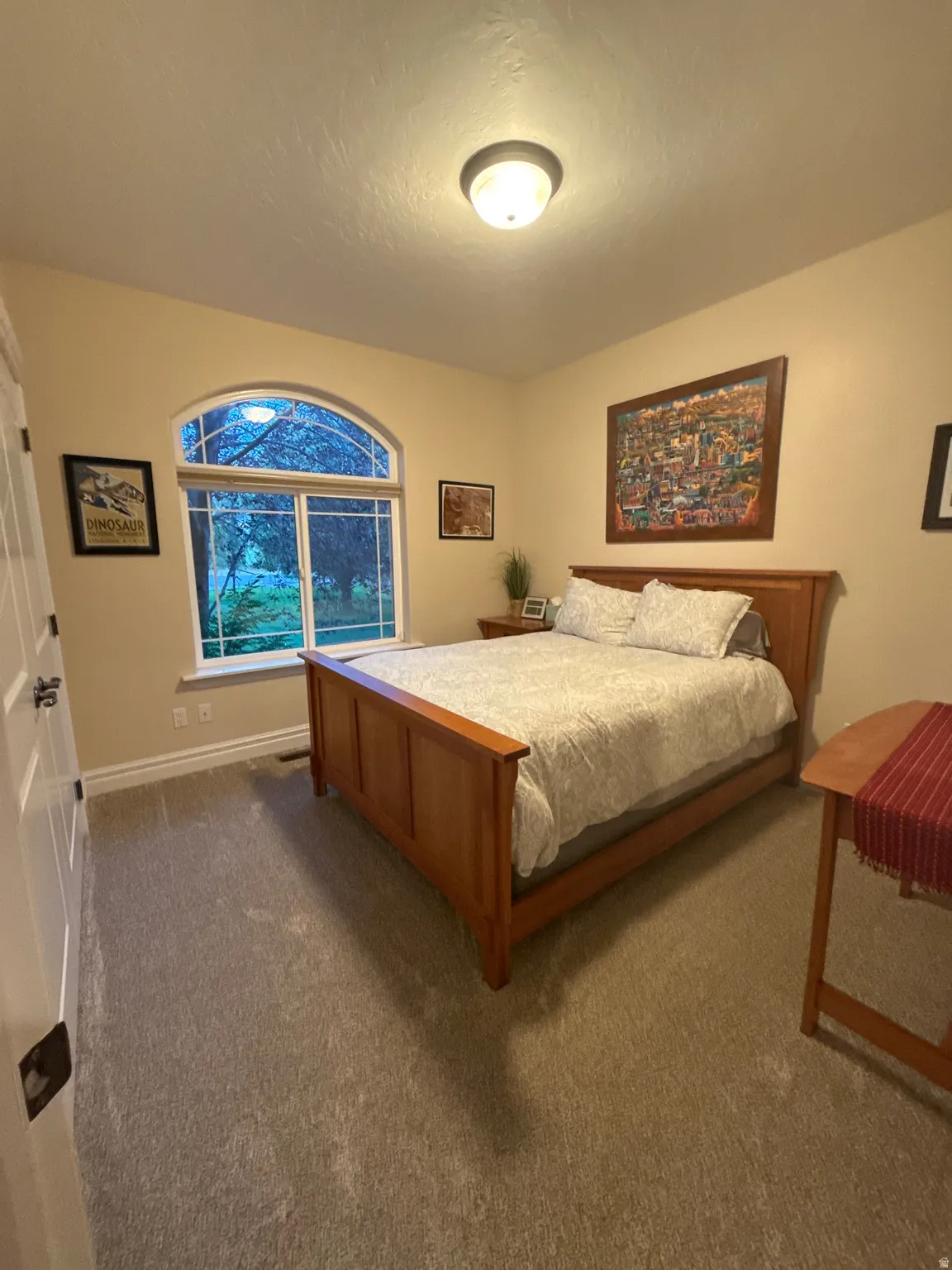 Bedroom featuring carpet flooring and baseboards