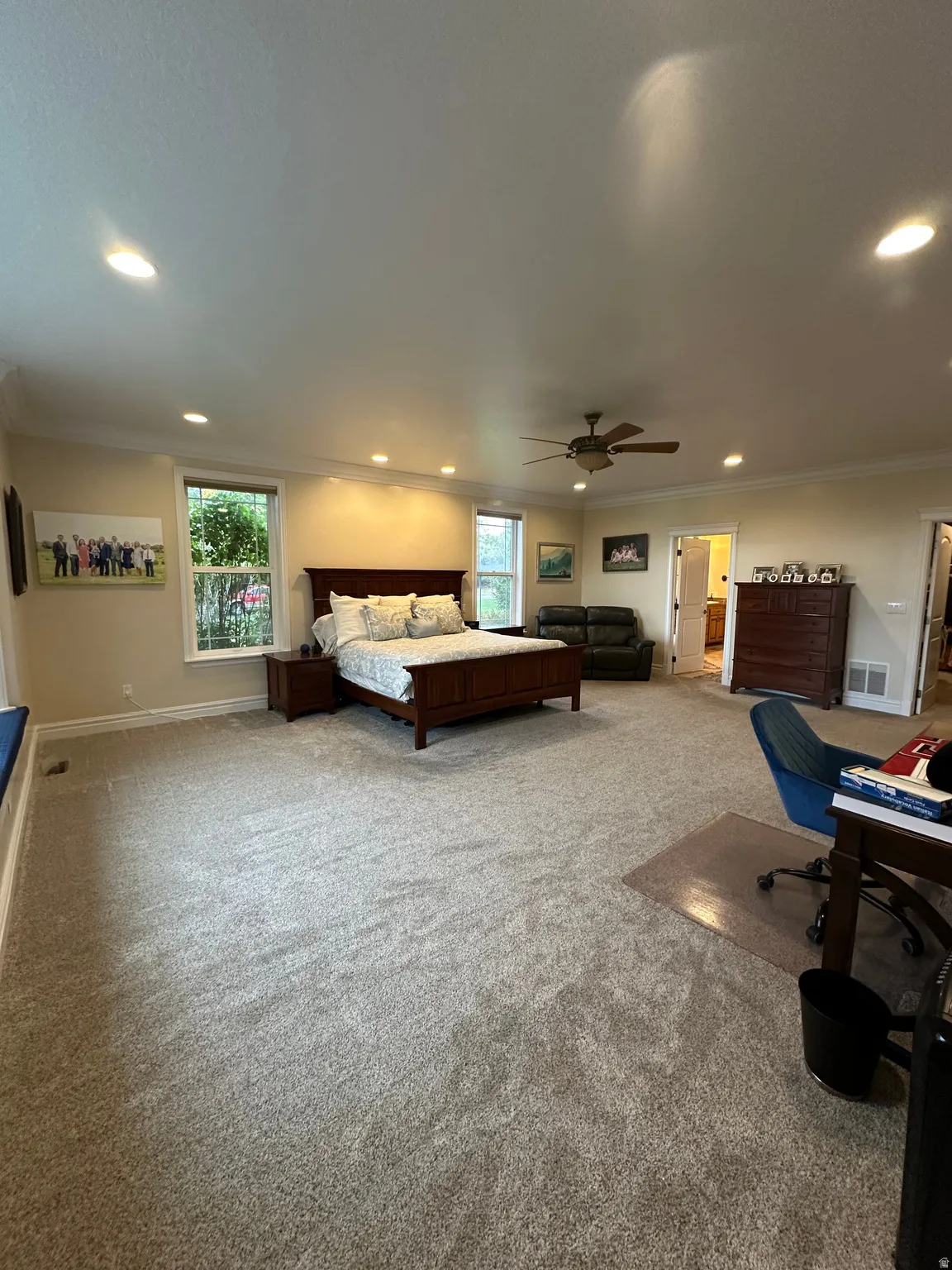 Bedroom with light colored carpet, recessed lighting, ornamental molding, a desk, and ceiling fan