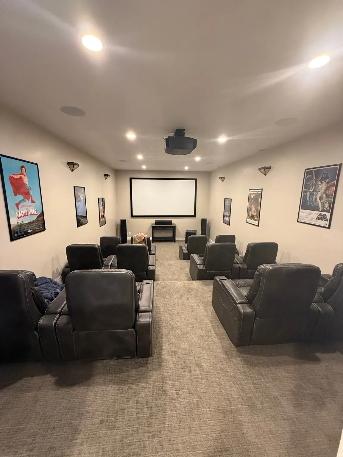 Carpeted home theater room with recessed lighting