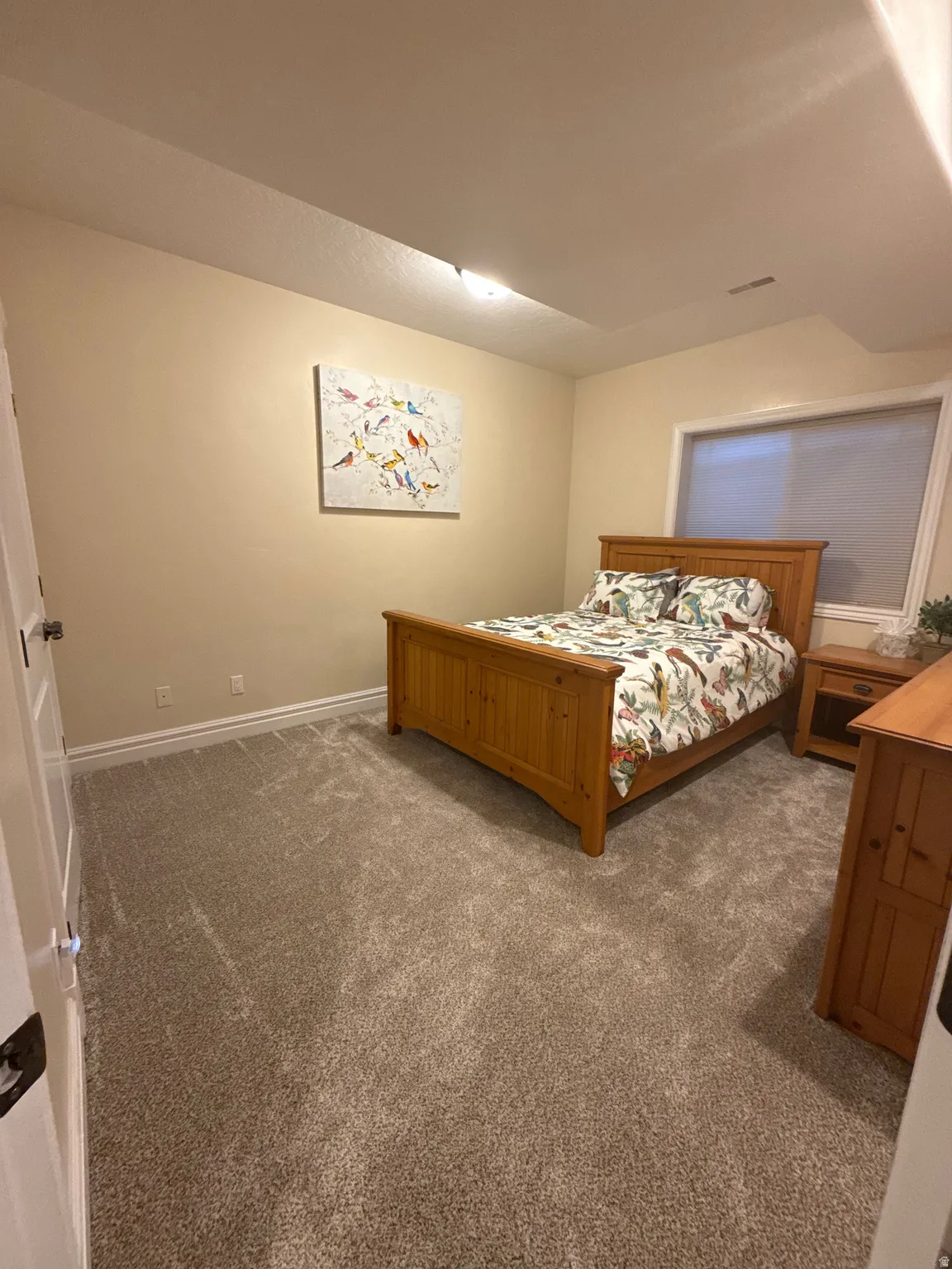 Bedroom with carpet floors and baseboards