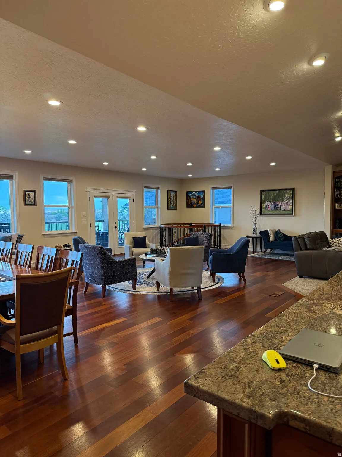 Living area with a textured ceiling, dark wood-type flooring, recessed lighting, and french doors