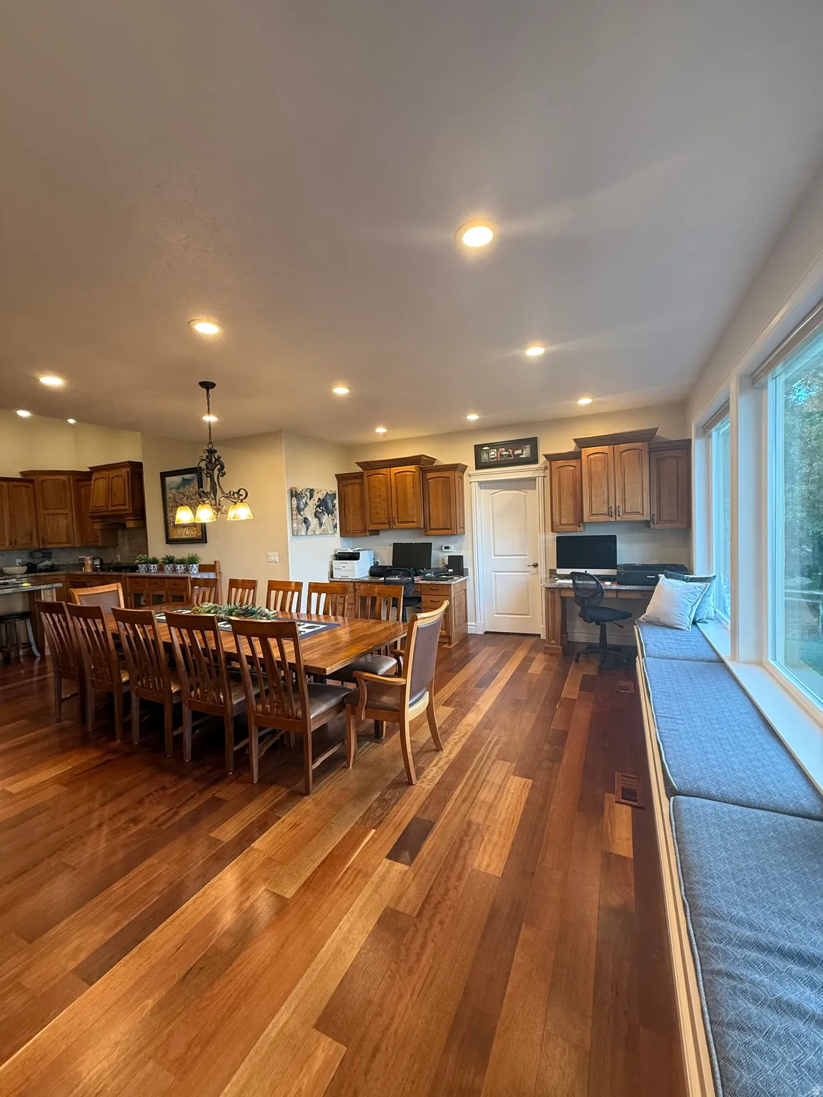 Dining room featuring dark wood-style floors and suspended lighting