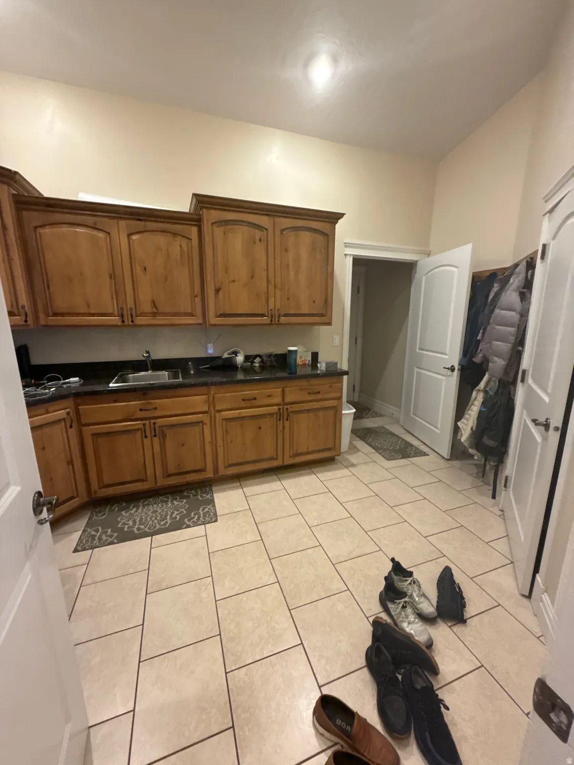 Kitchen featuring wood finish cabinetry and light tile patterned floors