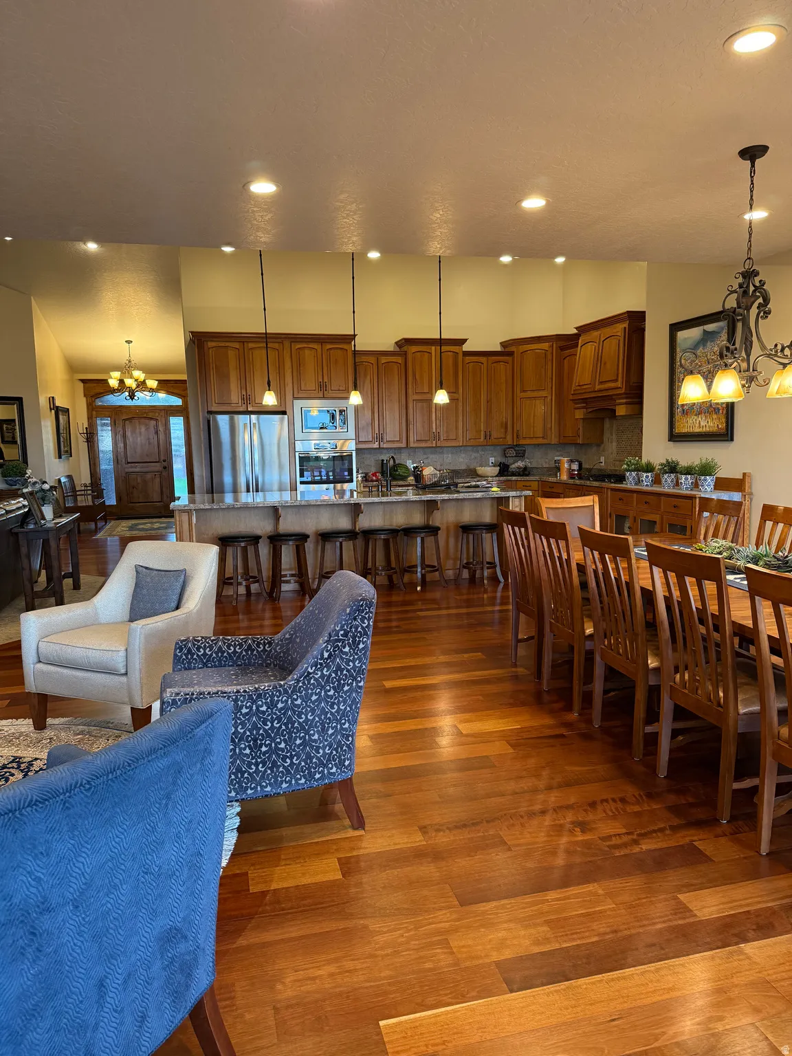 Dining space featuring a chandelier, dark wood finished floors, and vaulted ceiling