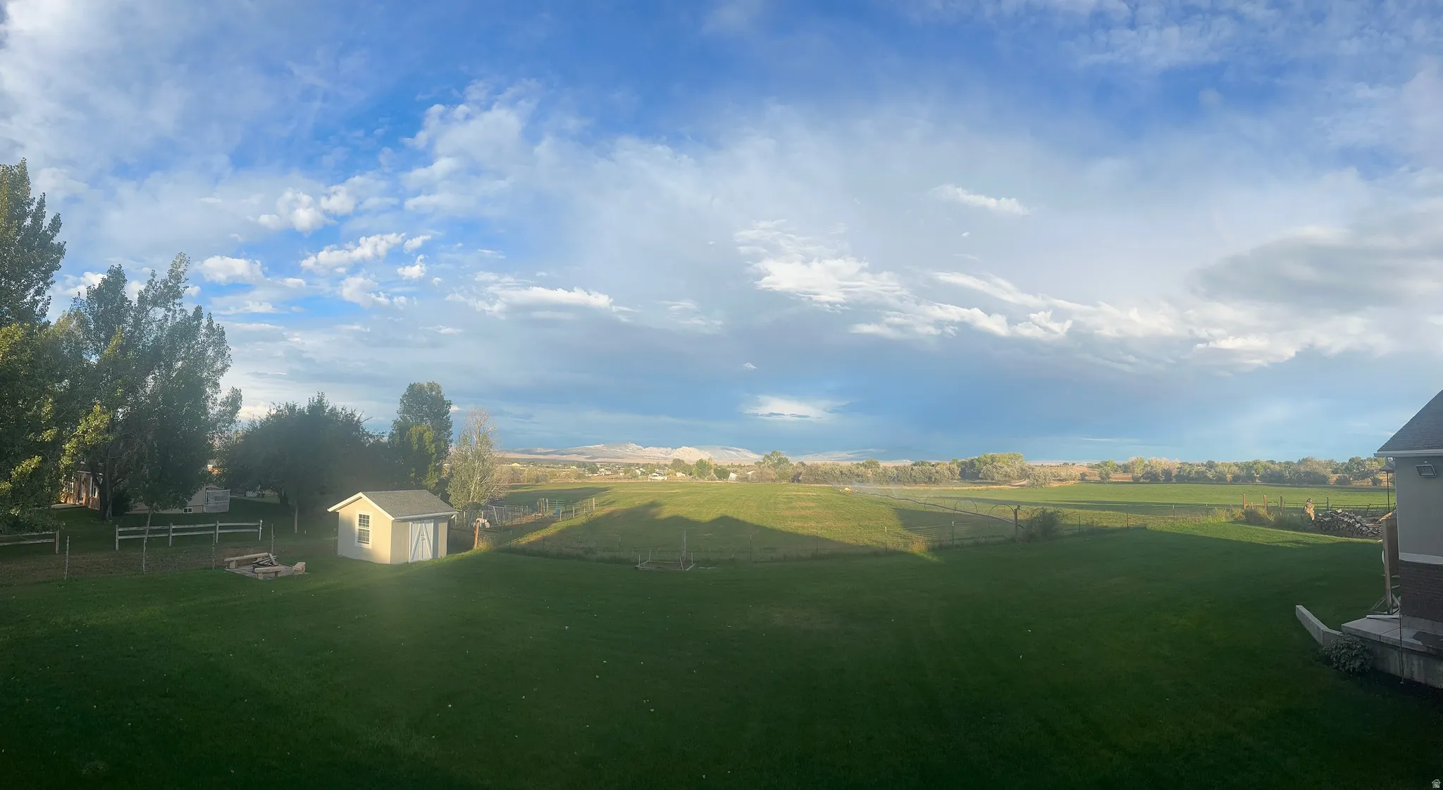 View of yard with a shed and a fire pit