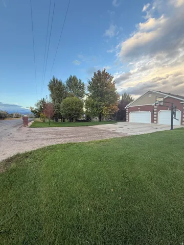 View of green lawn with driveway
