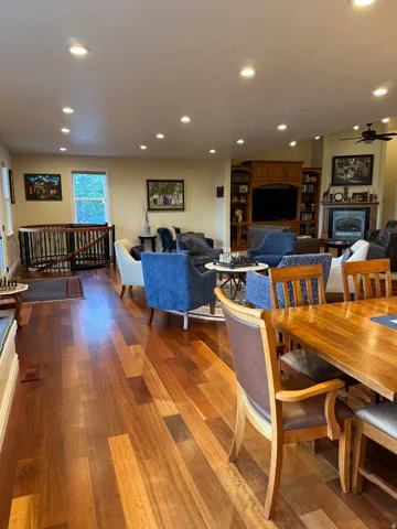Dining space with dark wood finished floors, recessed lighting, and a ceiling fan