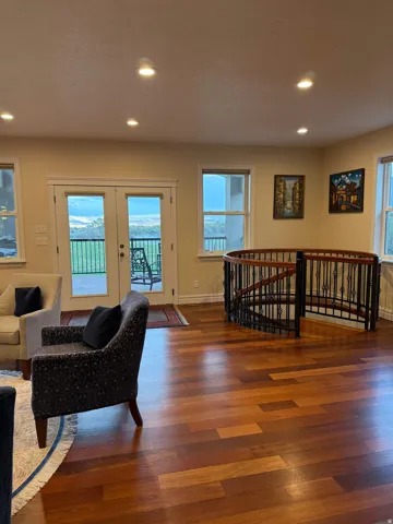 Living room with recessed lighting, wood finished floors, french doors, and plenty of natural light