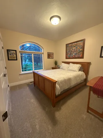 Bedroom featuring carpet flooring and baseboards