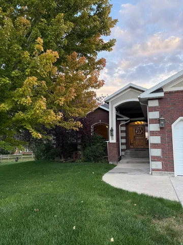 View of green lawn featuring a garage