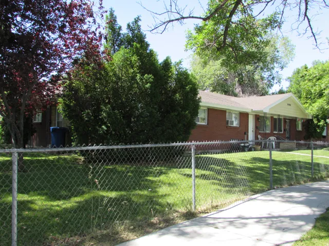 View of front of property featuring a fenced front yard and brick siding