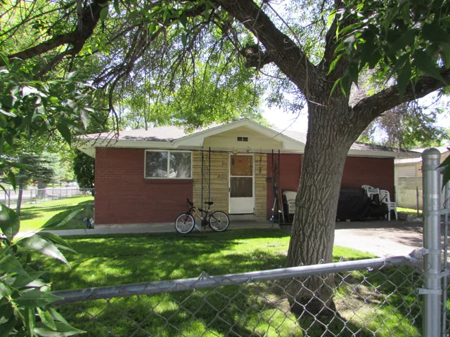 View of front of home featuring a fenced front yard and brick siding