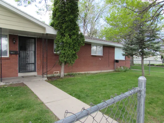 Property entrance featuring brick siding