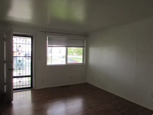 Empty room with dark wood-style floors