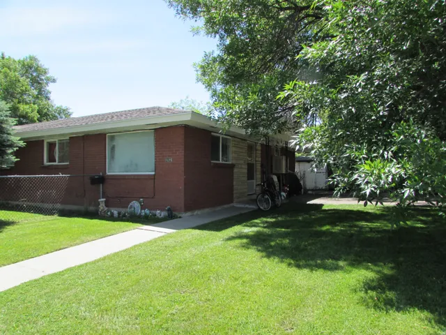 View of home's exterior featuring brick siding and roof with shingles