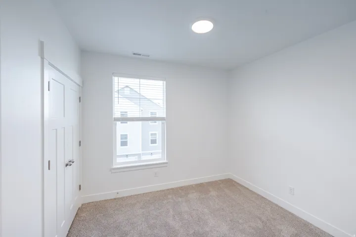 Bright room with neutral wall finishes and a window featuring white blinds