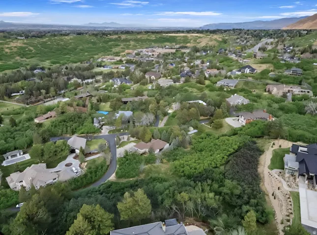 Aerial view of residential area featuring a mountainous background