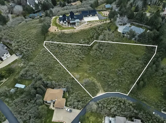 Aerial perspective of suburban area featuring property parcel outlined