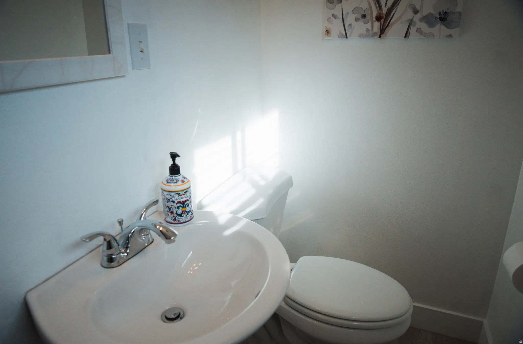 Half bath with a sink and toilet