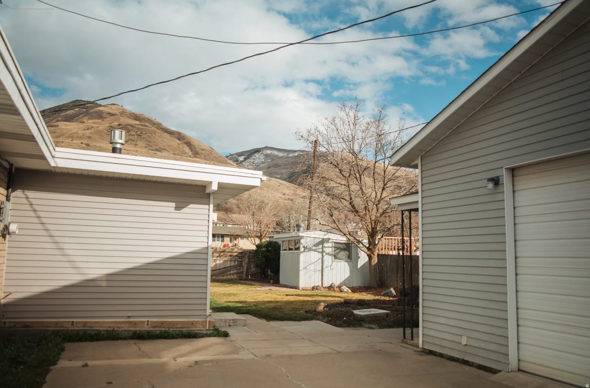 View of patio / terrace with a mountain view and two-car garage.