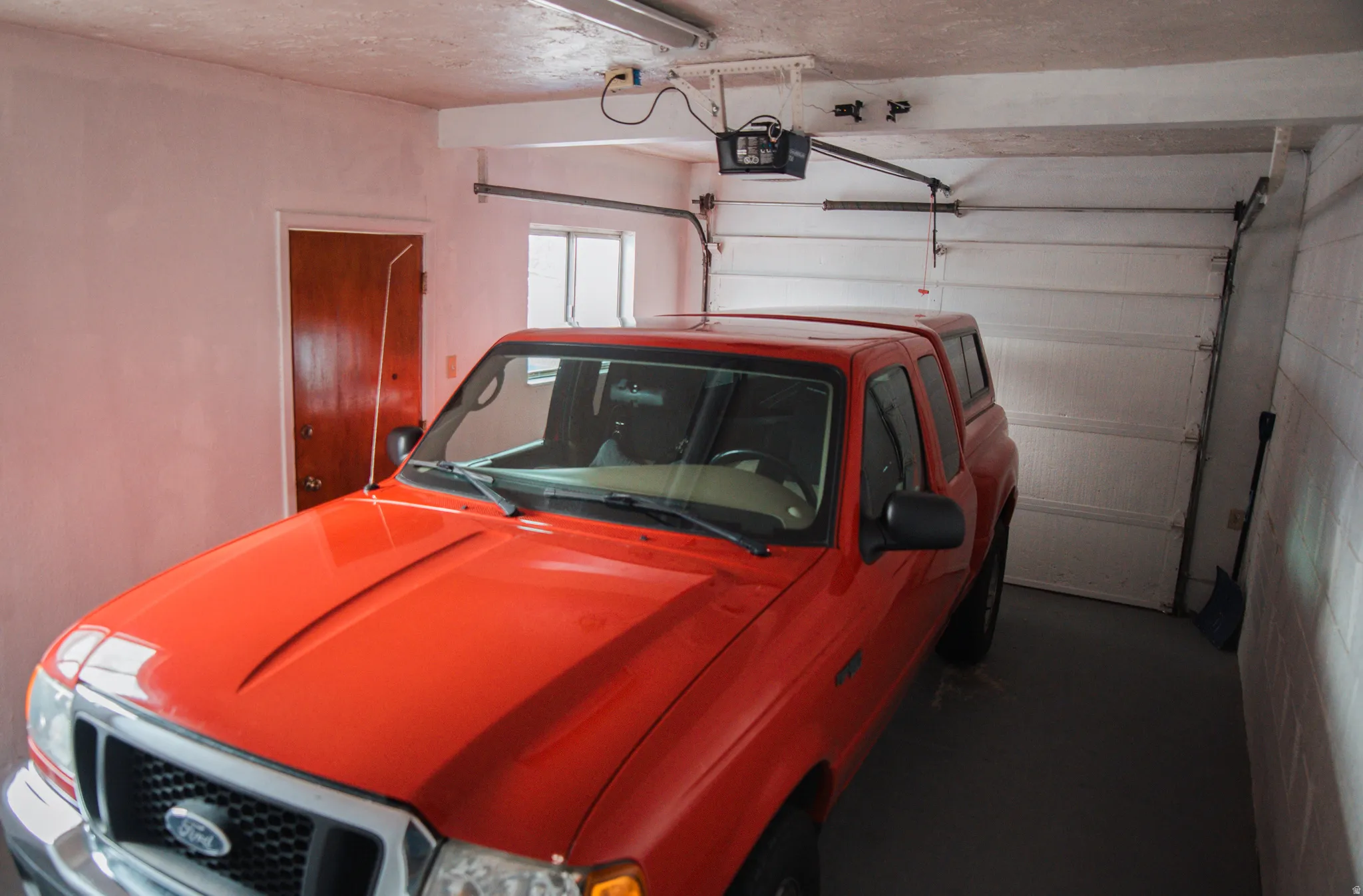 Garage featuring a garage door opener