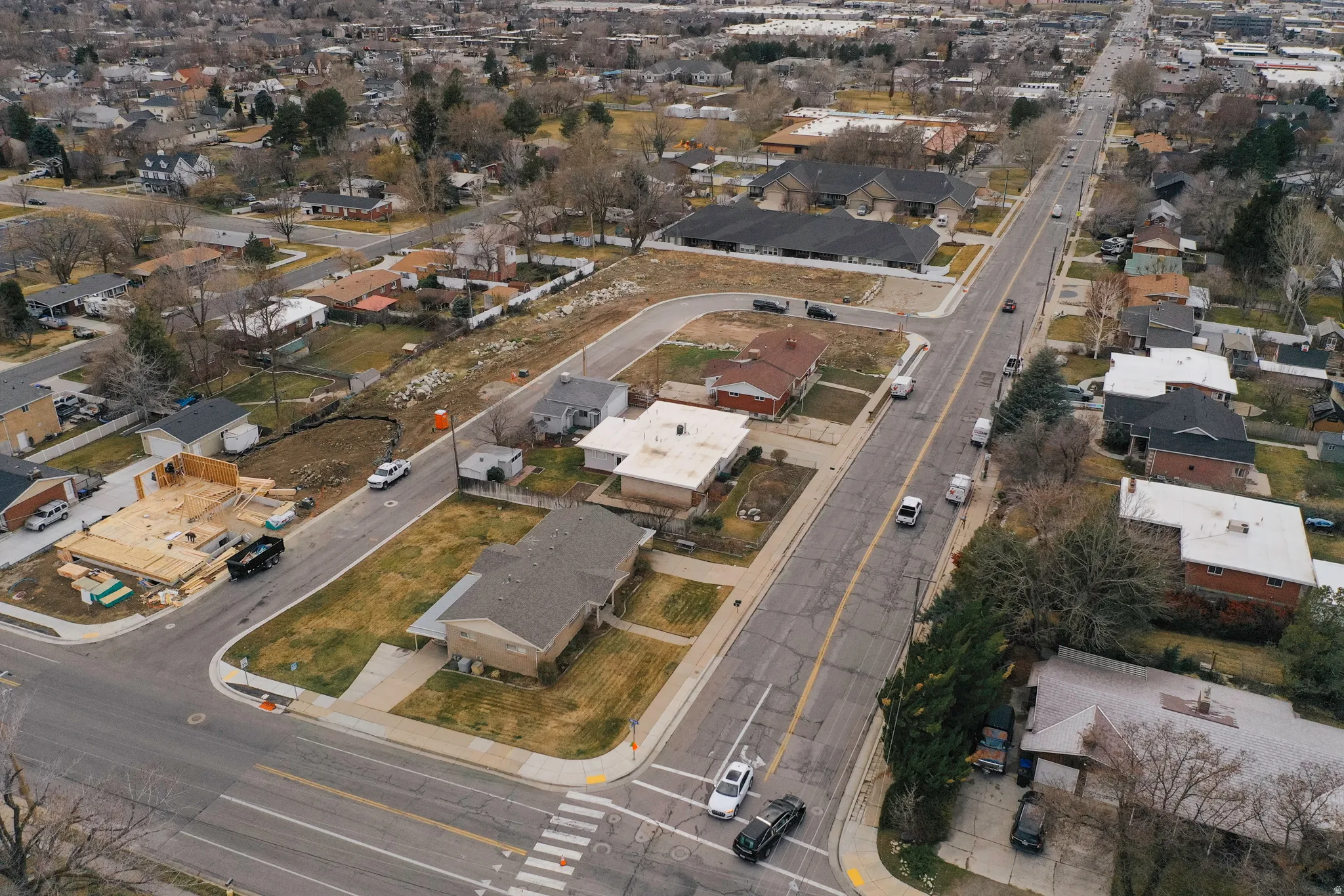 Aerial view of property and surrounding area with nearby suburban area
