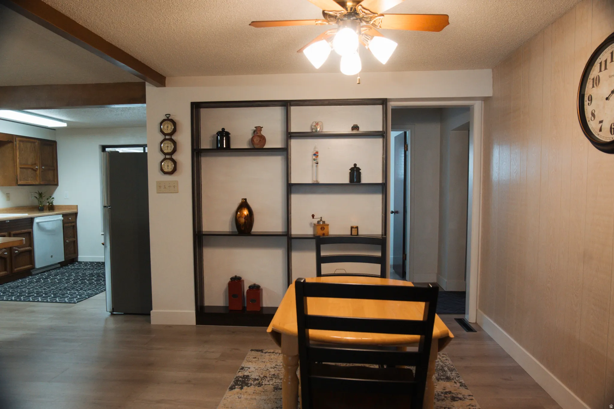 Informal dining room featuring LVP floors, ceiling fan, and a textured ceiling