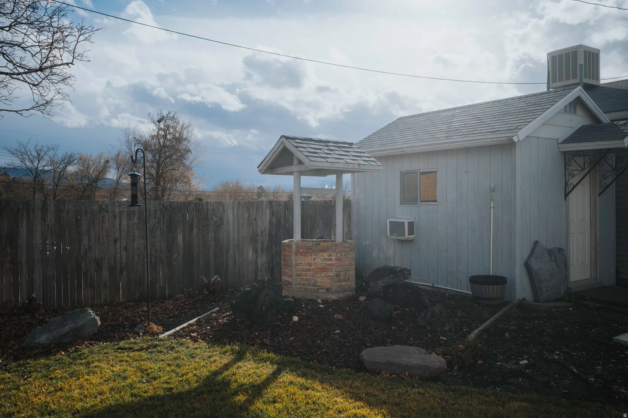 View of shed and fully fenced yard.