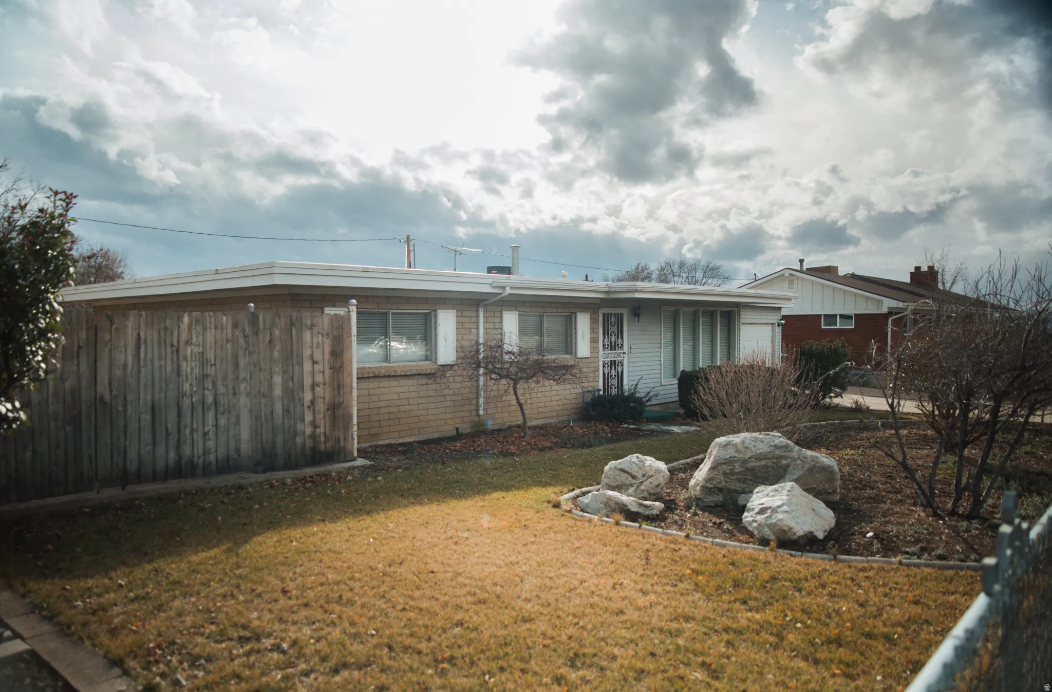 View of front of property with brick masonry and aluminum siding.