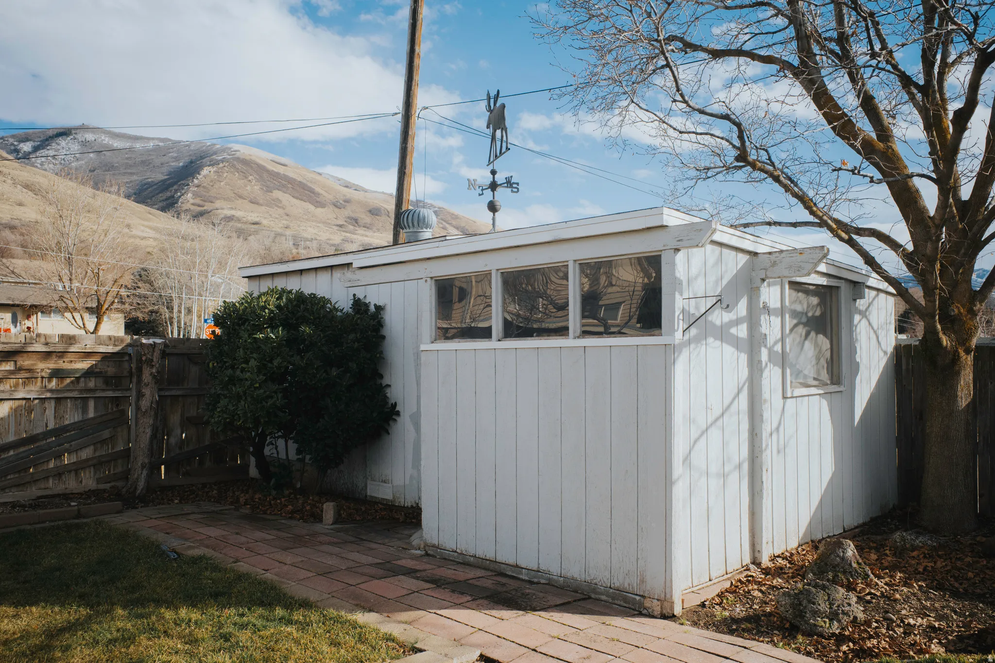 View of outbuilding featuring a fenced backyard and a mountain view