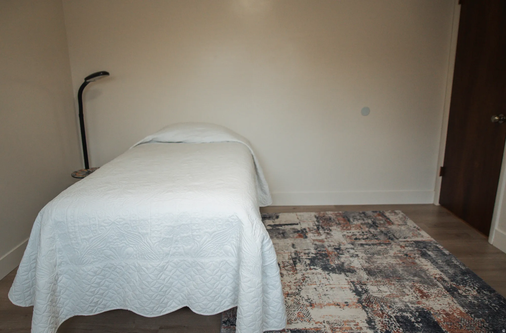Bedroom with LVP flooring and baseboards