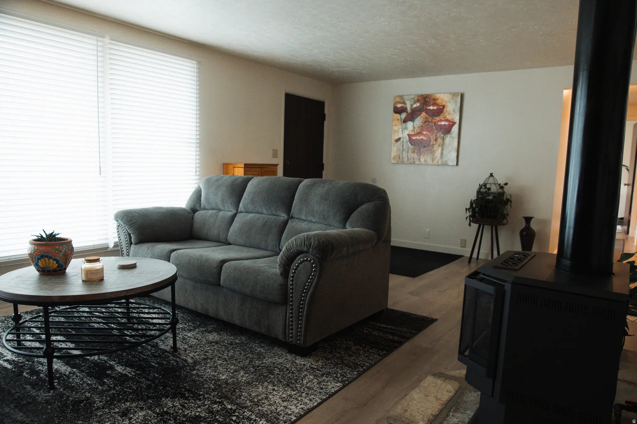 Living area with LVP flooring and a textured ceiling