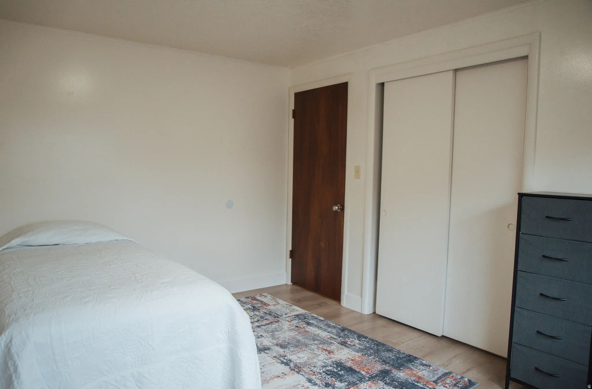 Bedroom featuring light, LVP flooring and a closet