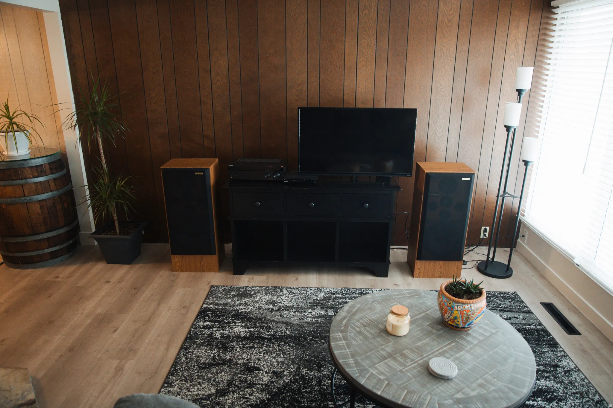Living area with wood walls and light LVP flooring.