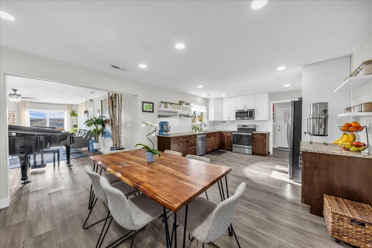 Dining room with light wood-style flooring, recessed lighting, and a ceiling fan