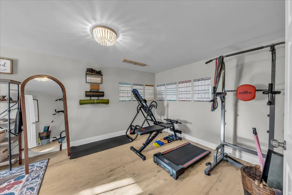 Exercise area featuring light wood-style floors and baseboards